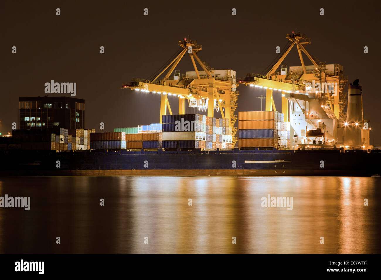 Big Container Cargo freight ship with working crane in shipyard at ...