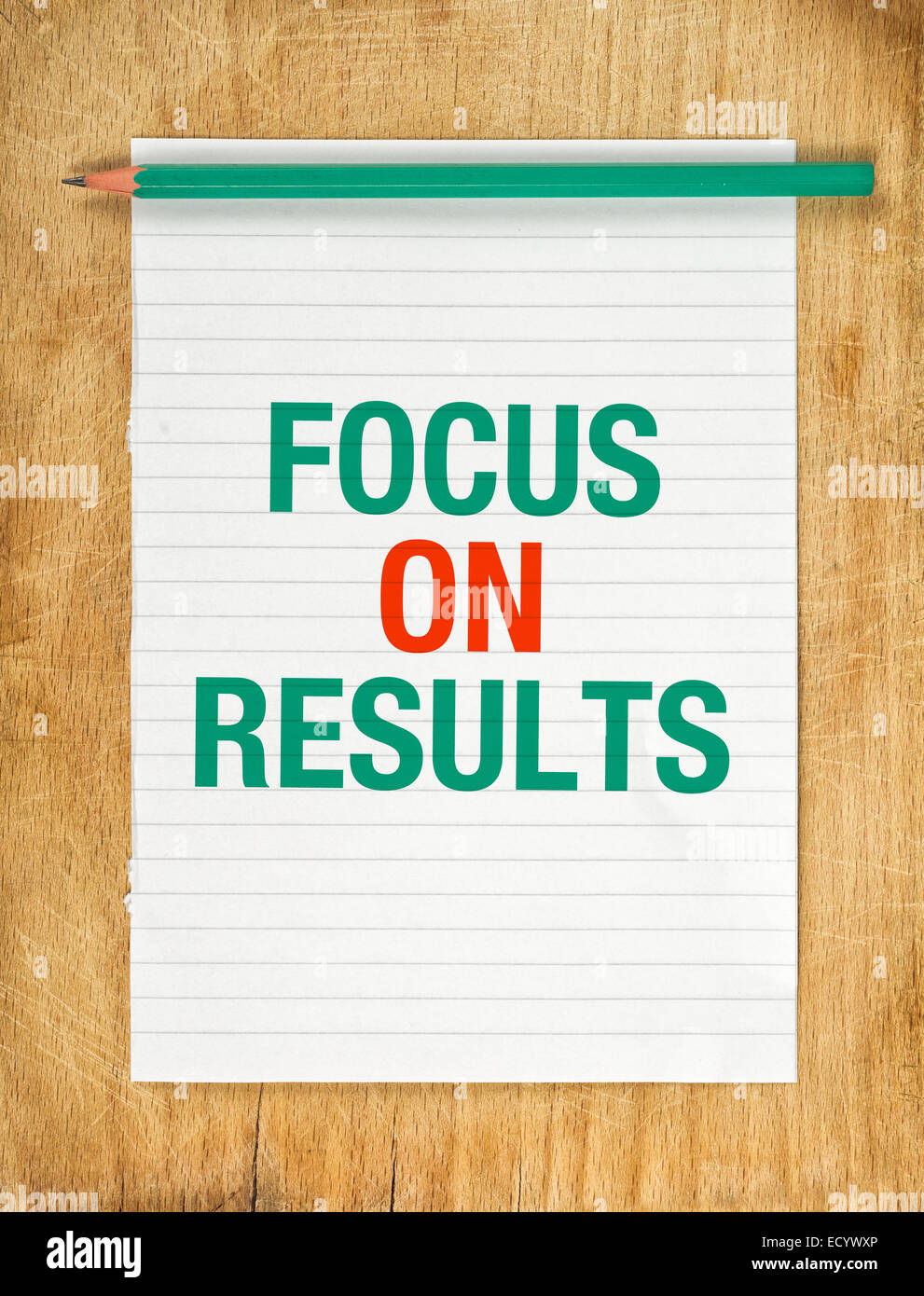 Focus On Results Message on Note Paper with Pencil on Wooden Office Table. Stock Photo