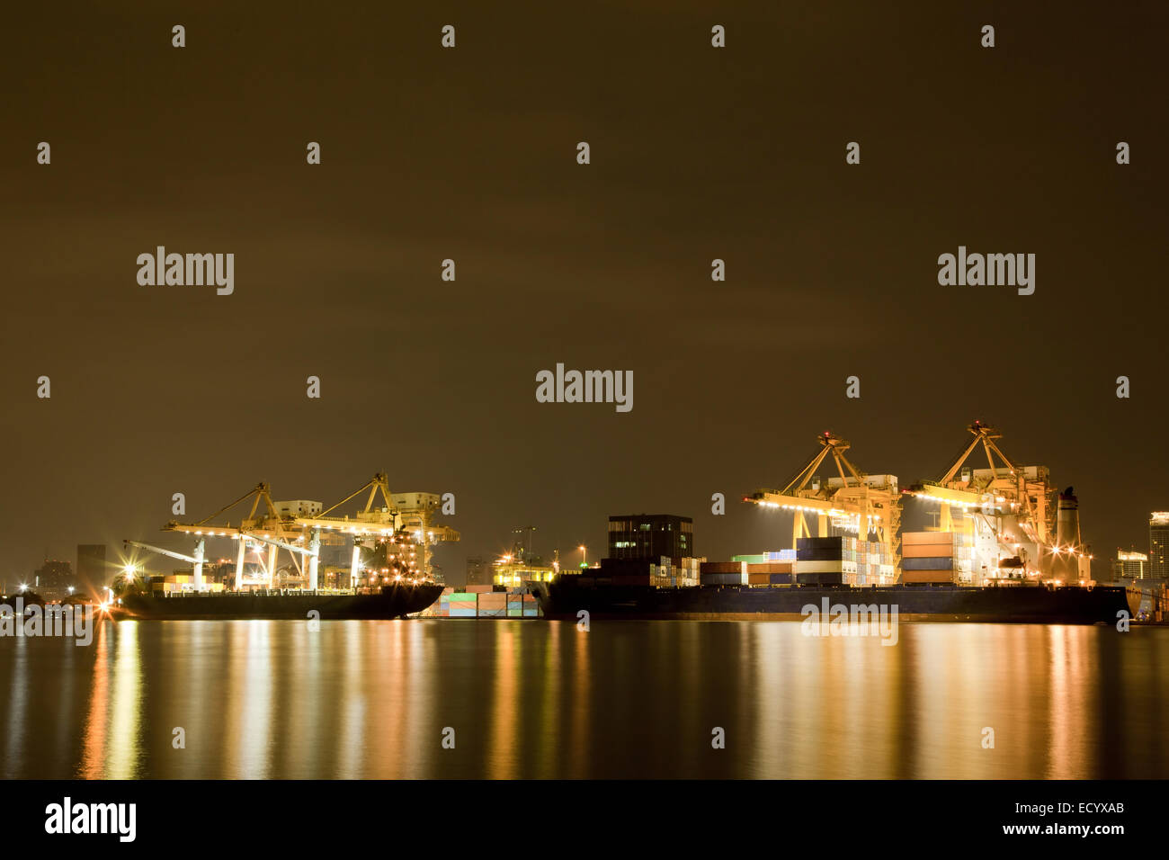 Big Container Cargo freight ship with working crane in shipyard at ...