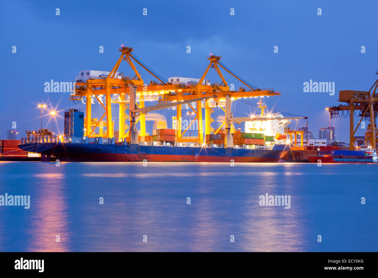 Container Cargo freight ship with working crane bridge in shipyard at ...