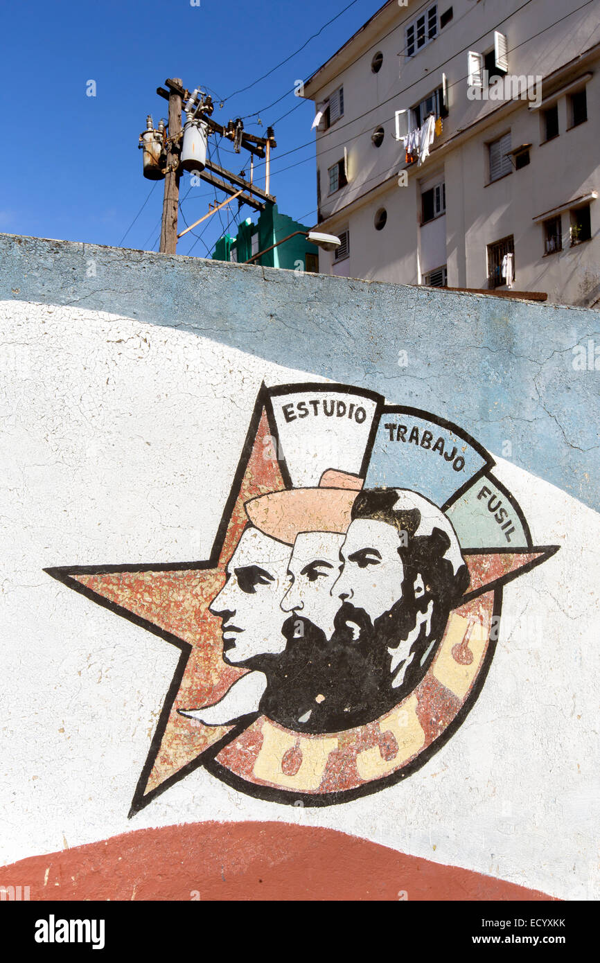 Mural showing Julio Antonio Mella, Camilo Cienfuegos and Che Guevara.It says:Estudio, Trabajo, Fusil and means Study, Work,Rifle Stock Photo