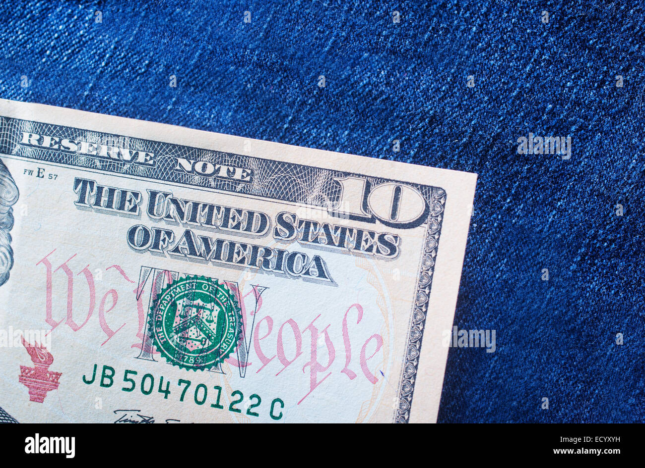 ten dollar note in the back pocket of denim trousers Stock Photo