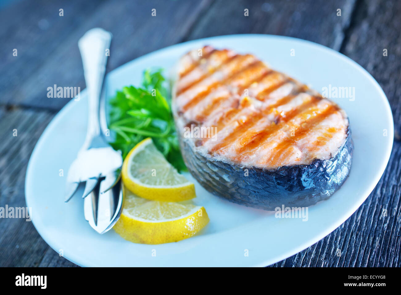 grilled salmon steak with lemon on white plate Stock Photo - Alamy