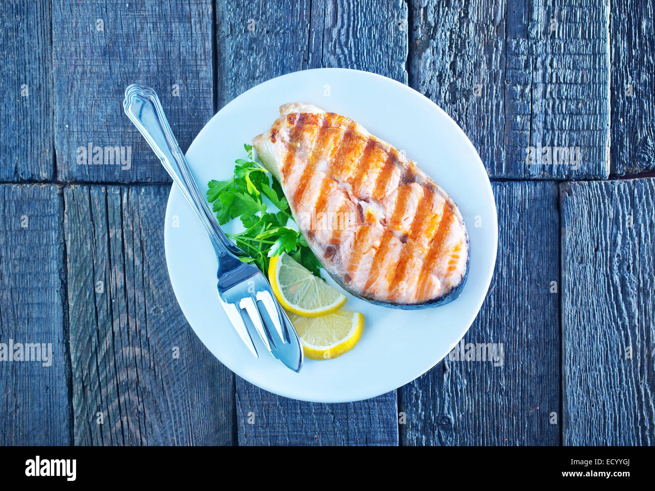 grilled salmon steak with lemon on white plate Stock Photo - Alamy