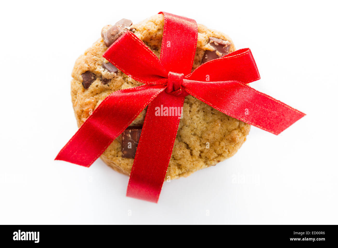 close up of home made chocolate chip cookies with a red ribbon isolated ...