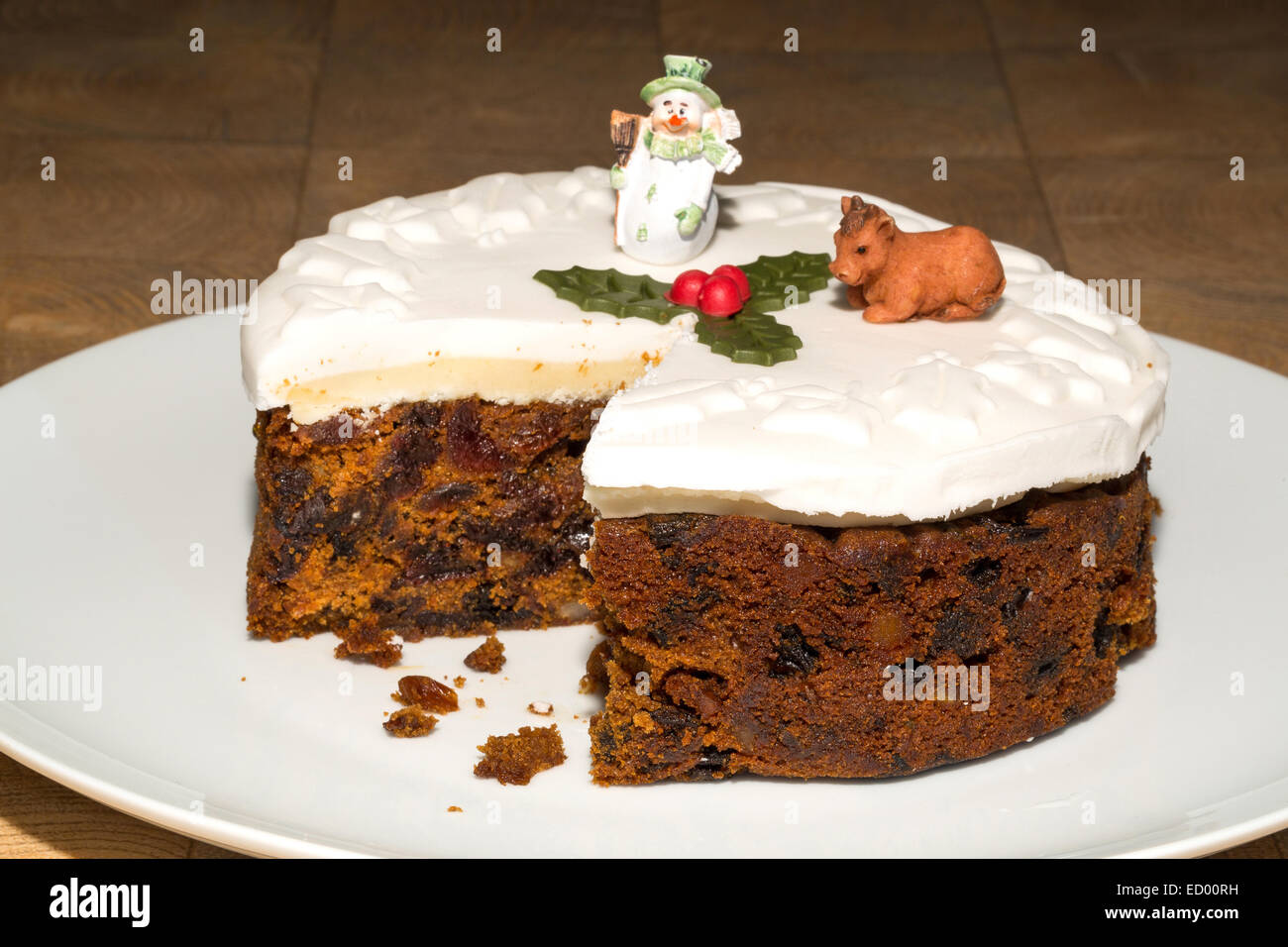 A fondant iced Christmas cake with a slice removed Stock Photo