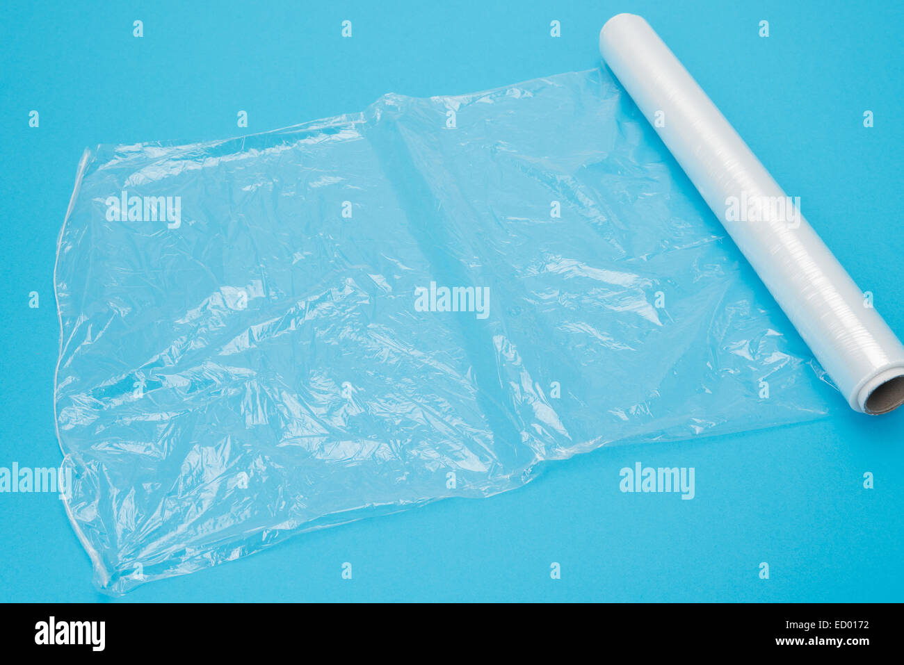 Clear stretch cling film pulled out over a plain background - studio shot Stock Photo