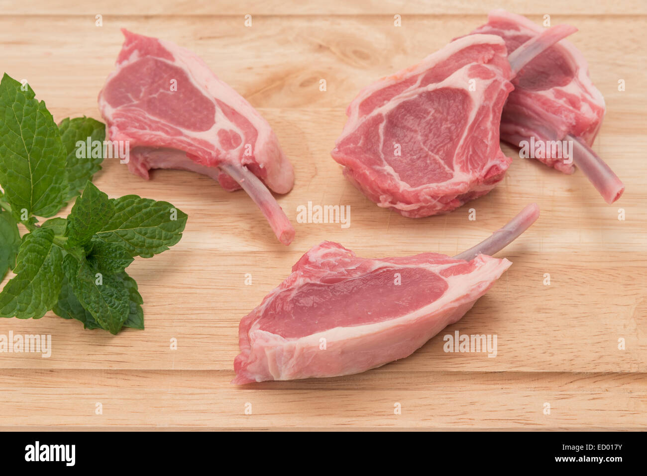 Four raw lamb chop cutlets Stock Photo