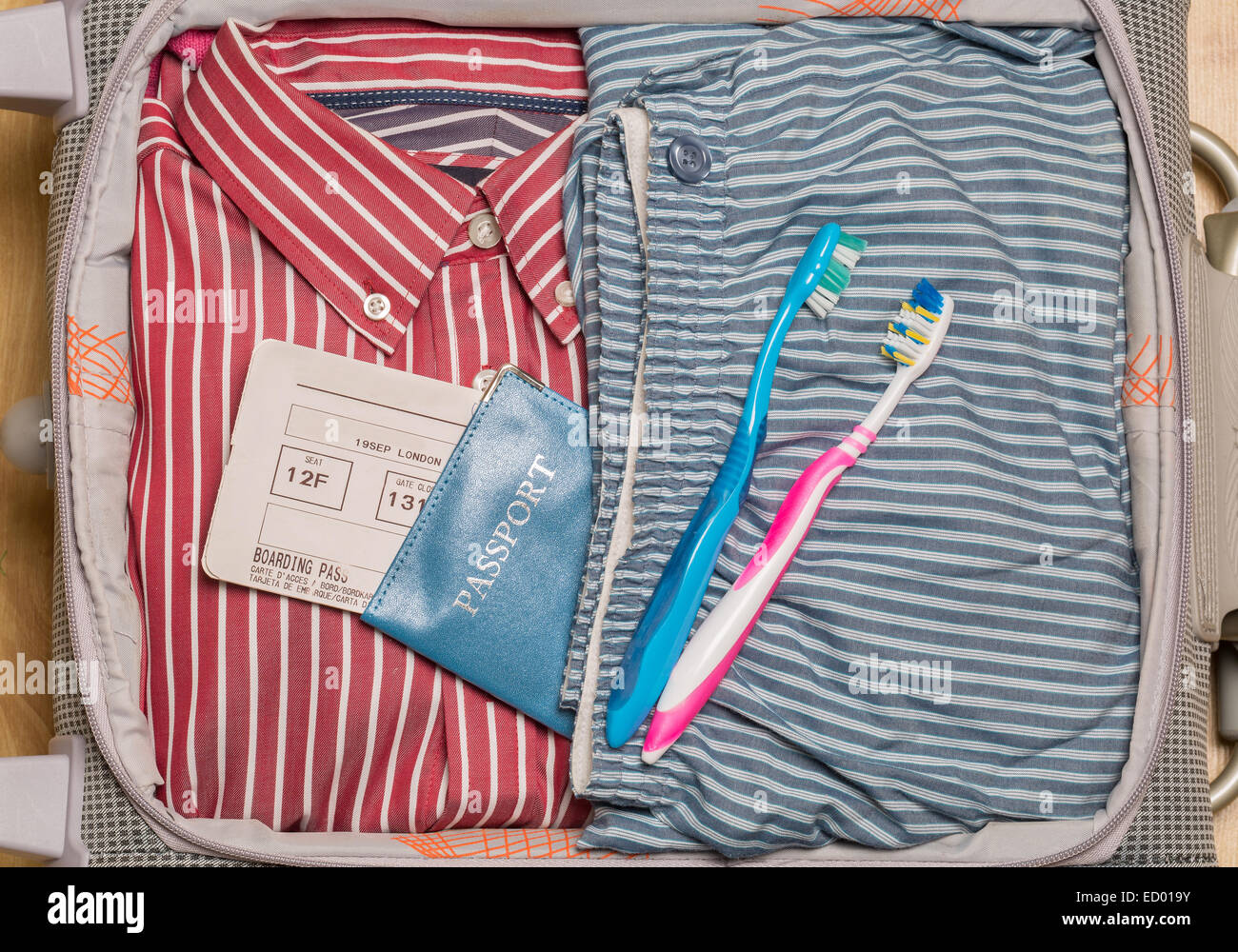 A suitcase full of clothes and ready to travel Stock Photo Alamy