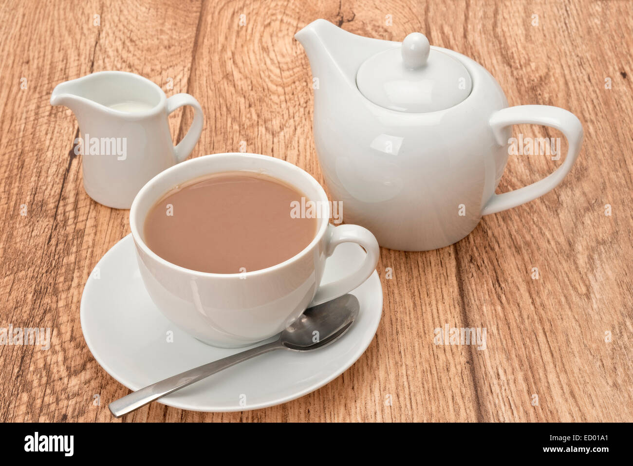 A cup of fresh brewed tea and a teapot Stock Photo