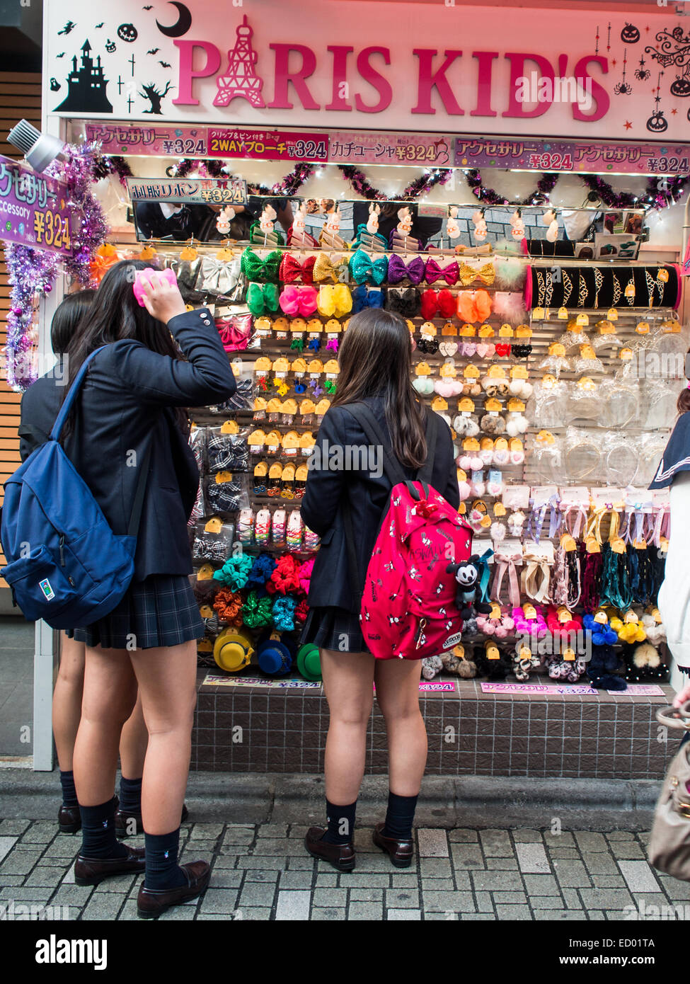 Japanese school girls shopping in Harajuku Stock Photo