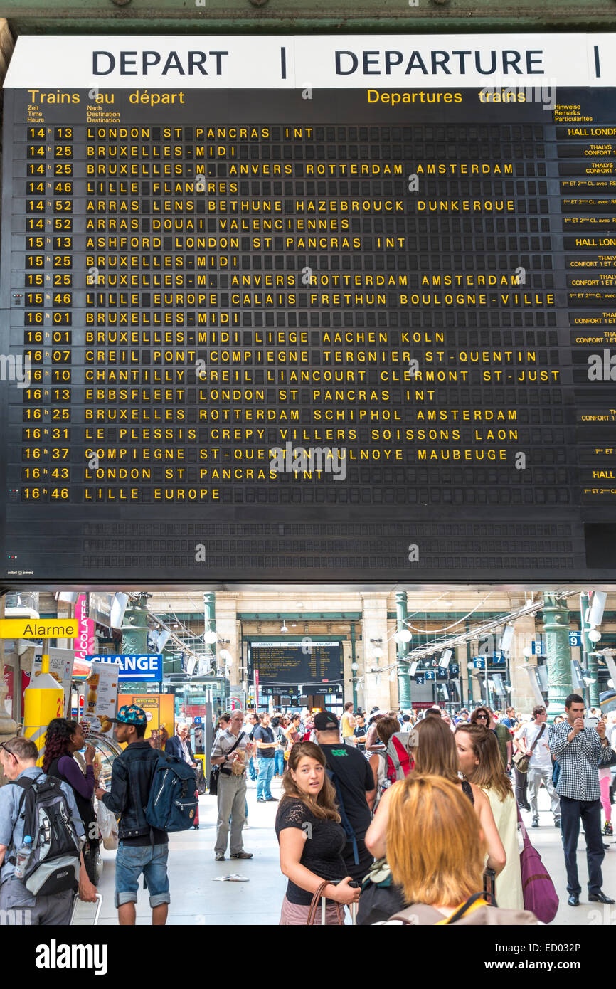 Paris Gare du Nord Station with travelers under train departure board with Paris to London Eurostar schedule time table Stock Photo