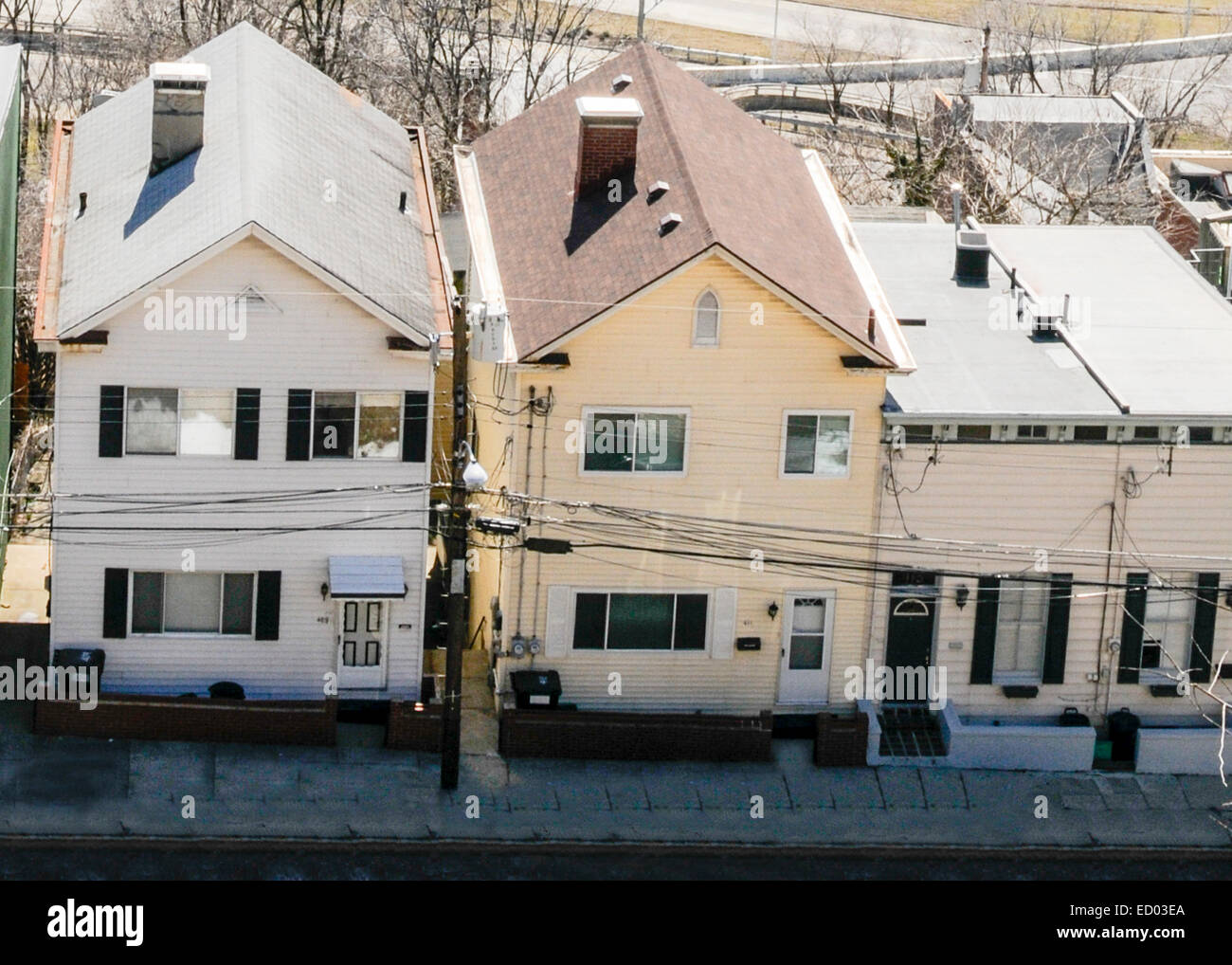Three houses in the suburbs of a big city in the USA.  The houses are small two story. Stock Photo