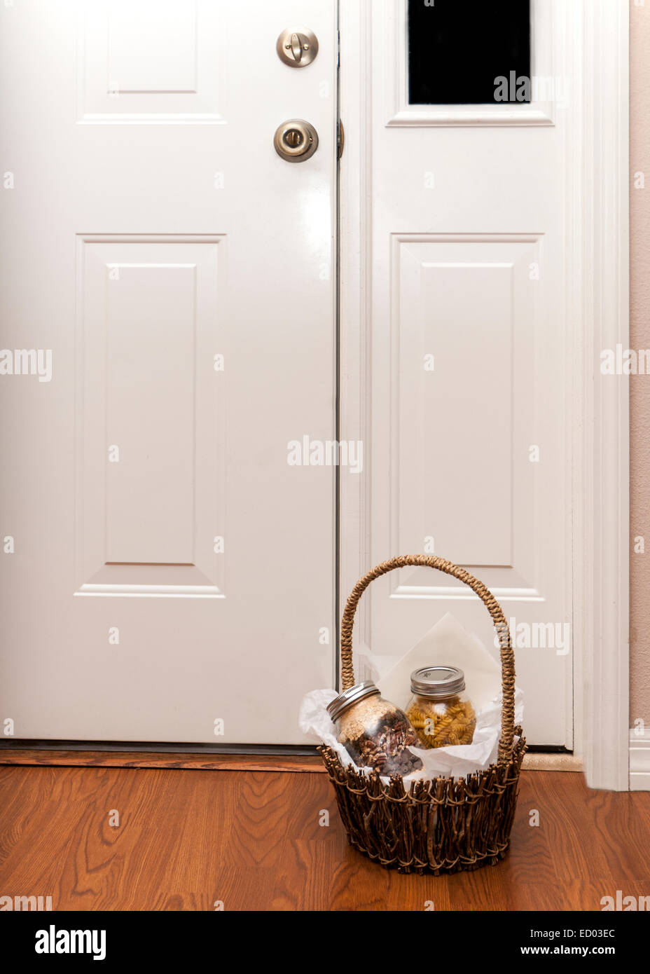 Brown basket sitting by a door with two jars filled with product inside