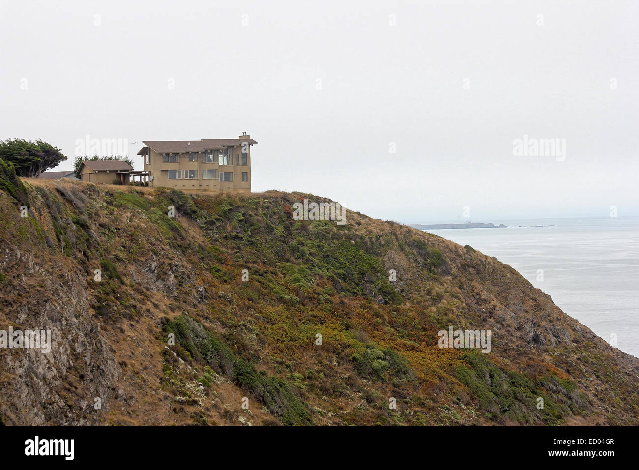 A large home on a cliff overlooks the Pacific Ocean. Mendocino County, California Stock Photo