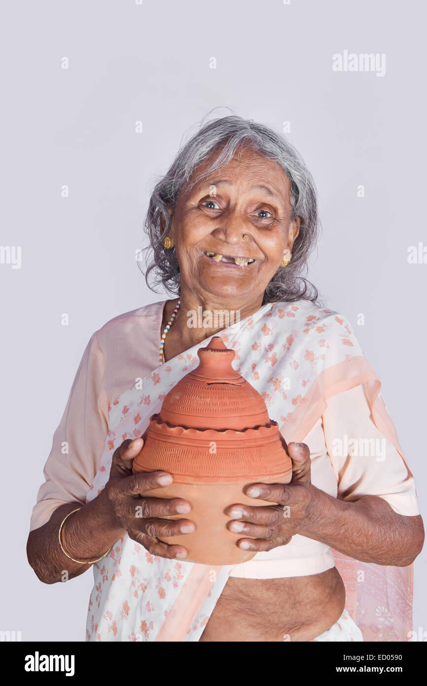 1 indian Old Senior Woman Saving money Piggy Bank Stock Photo - Alamy