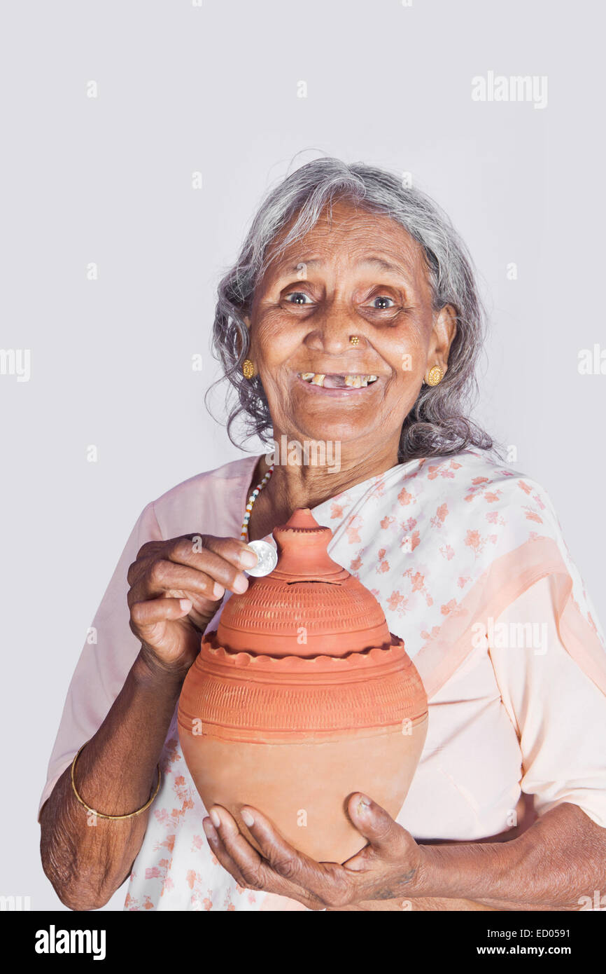 1 indian Old Senior Woman Saving money Piggy Bank Stock Photo