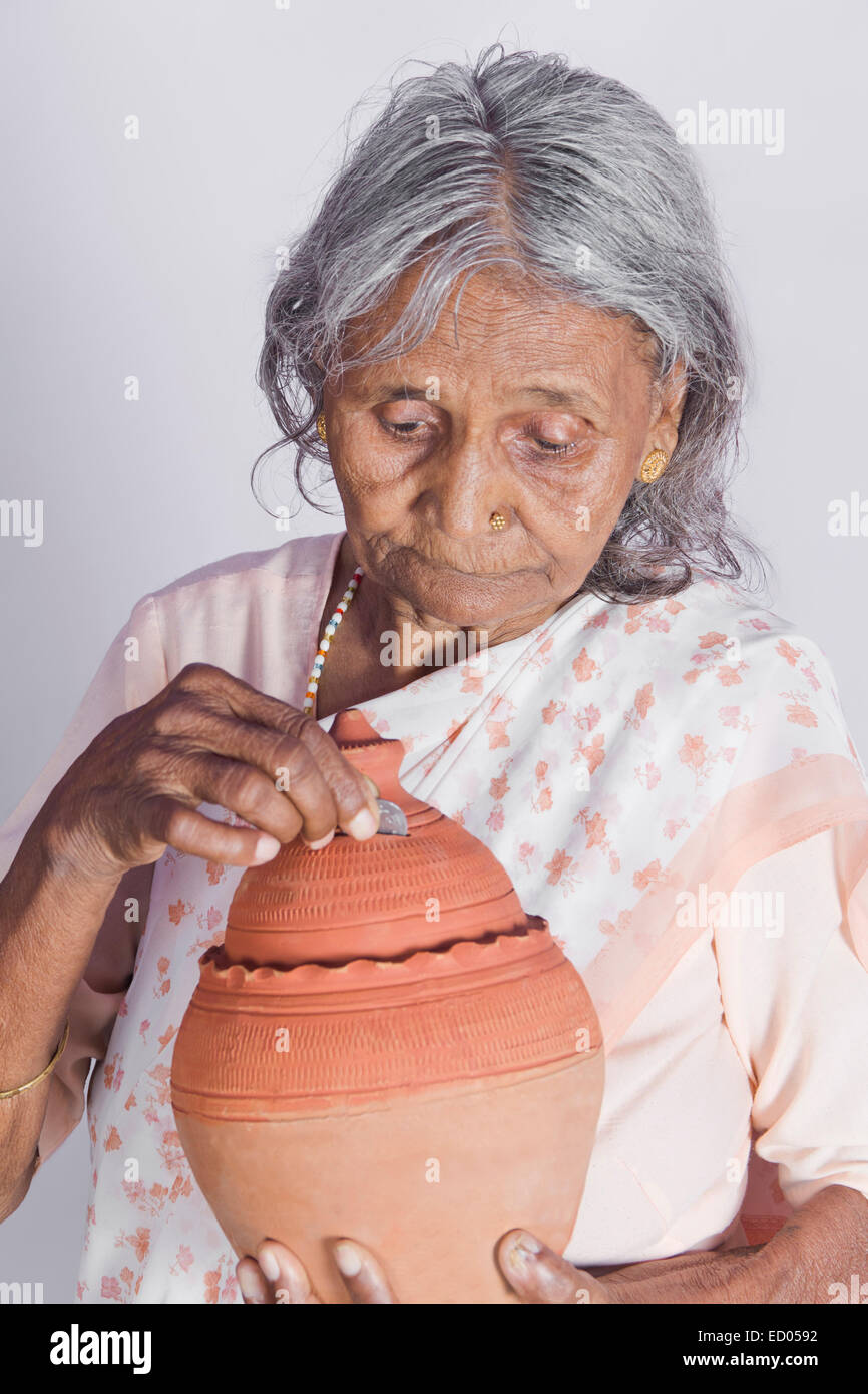 1 indian Old Senior Woman Saving money Piggy Bank Stock Photo - Alamy