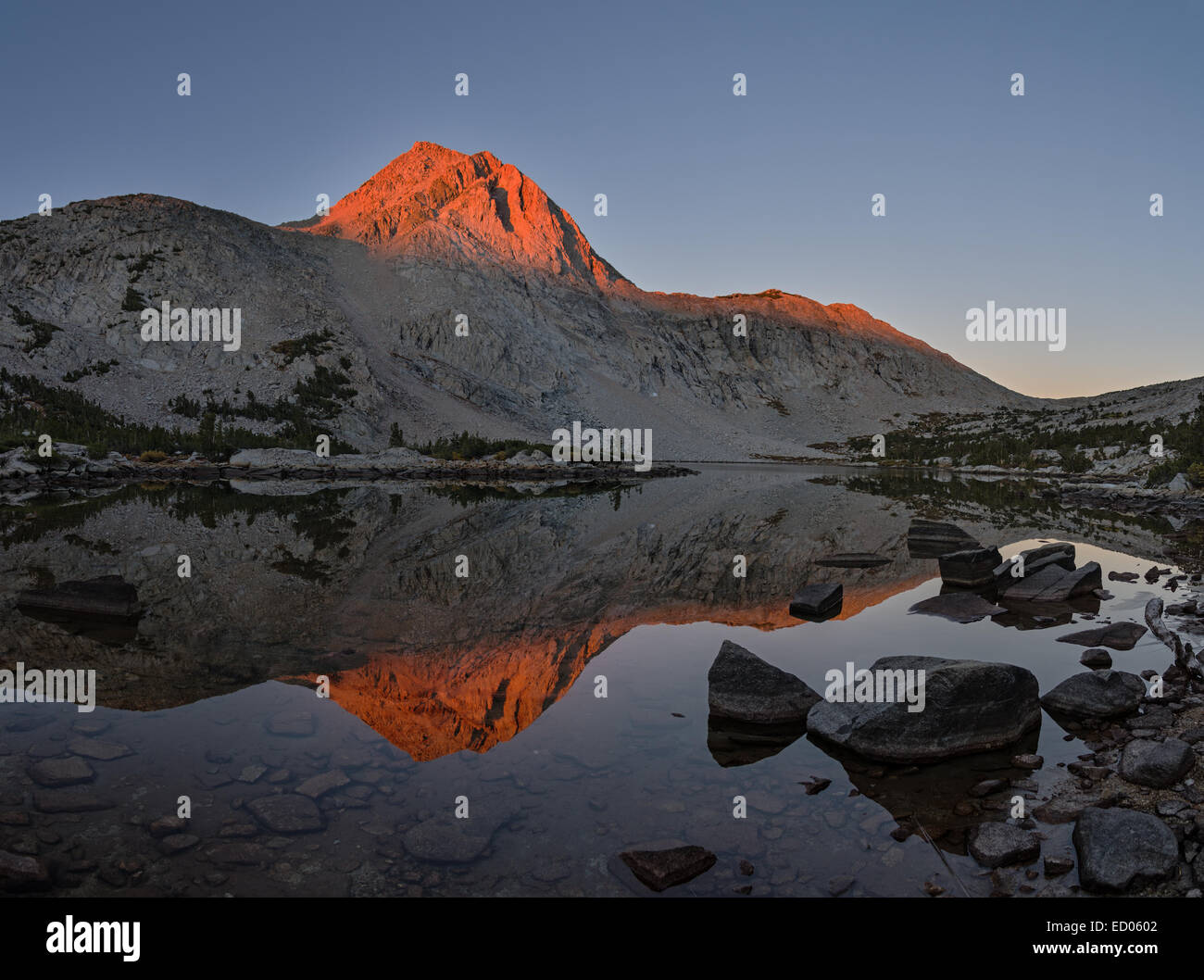 early morning light on the mountain reflected in Piute Lake Stock Photo