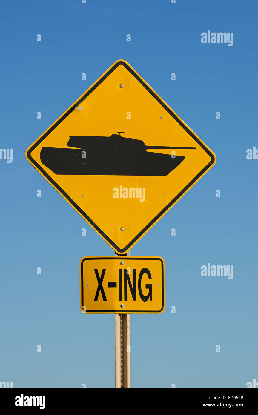 yellow and black tank crossing road sign on a military base Stock Photo