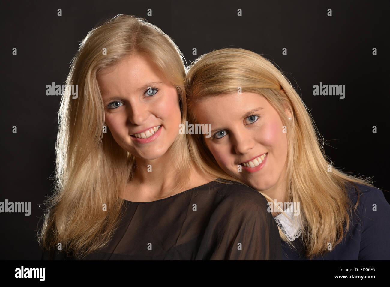 Studio portrait of a young blonde sisters (20's) Stock Photo