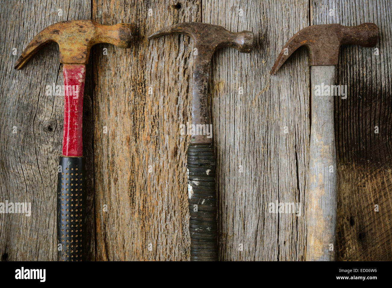 Old Hammers on Rustic Wood Background Stock Photo