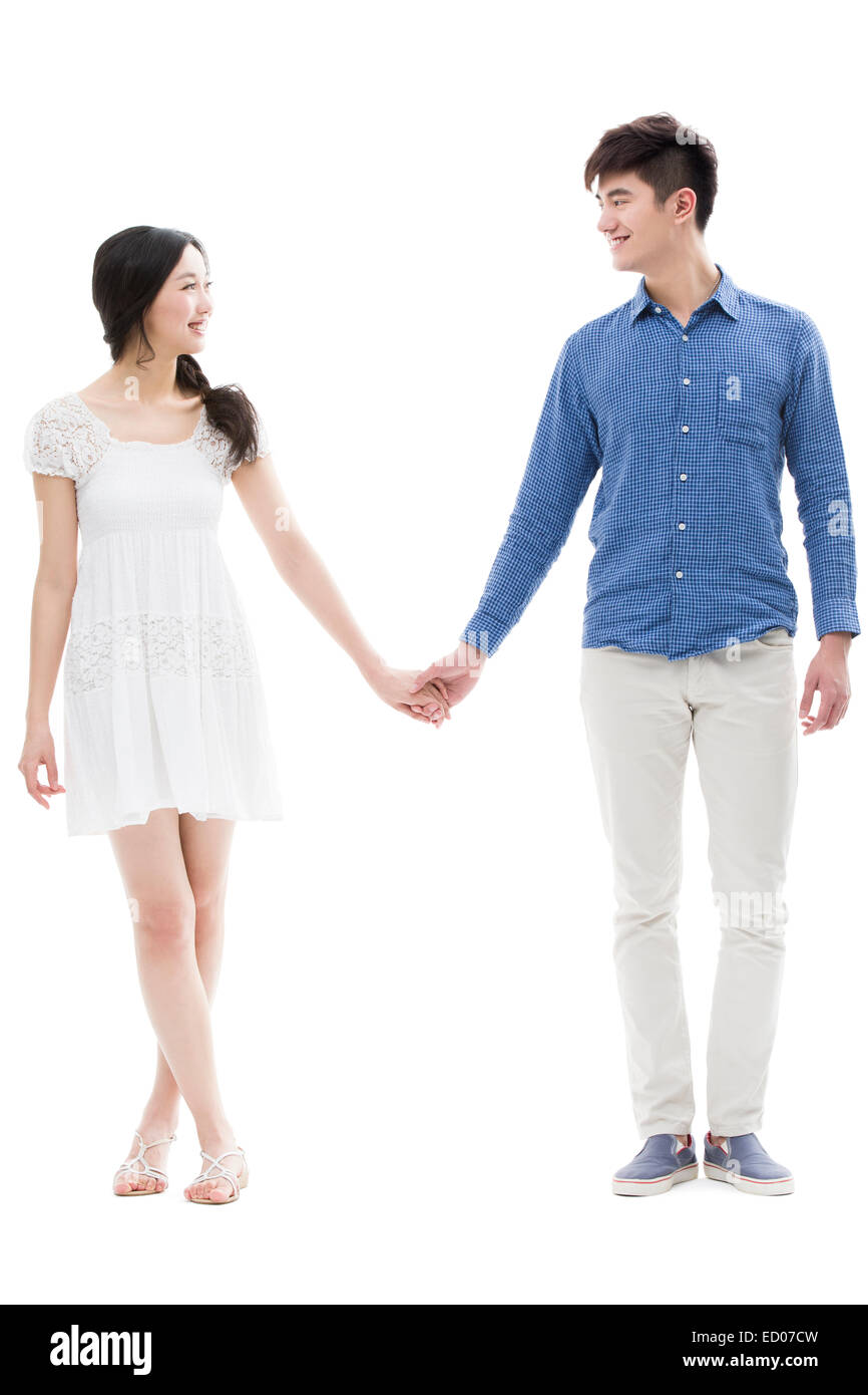 Happy young couple holding hands Stock Photo - Alamy
