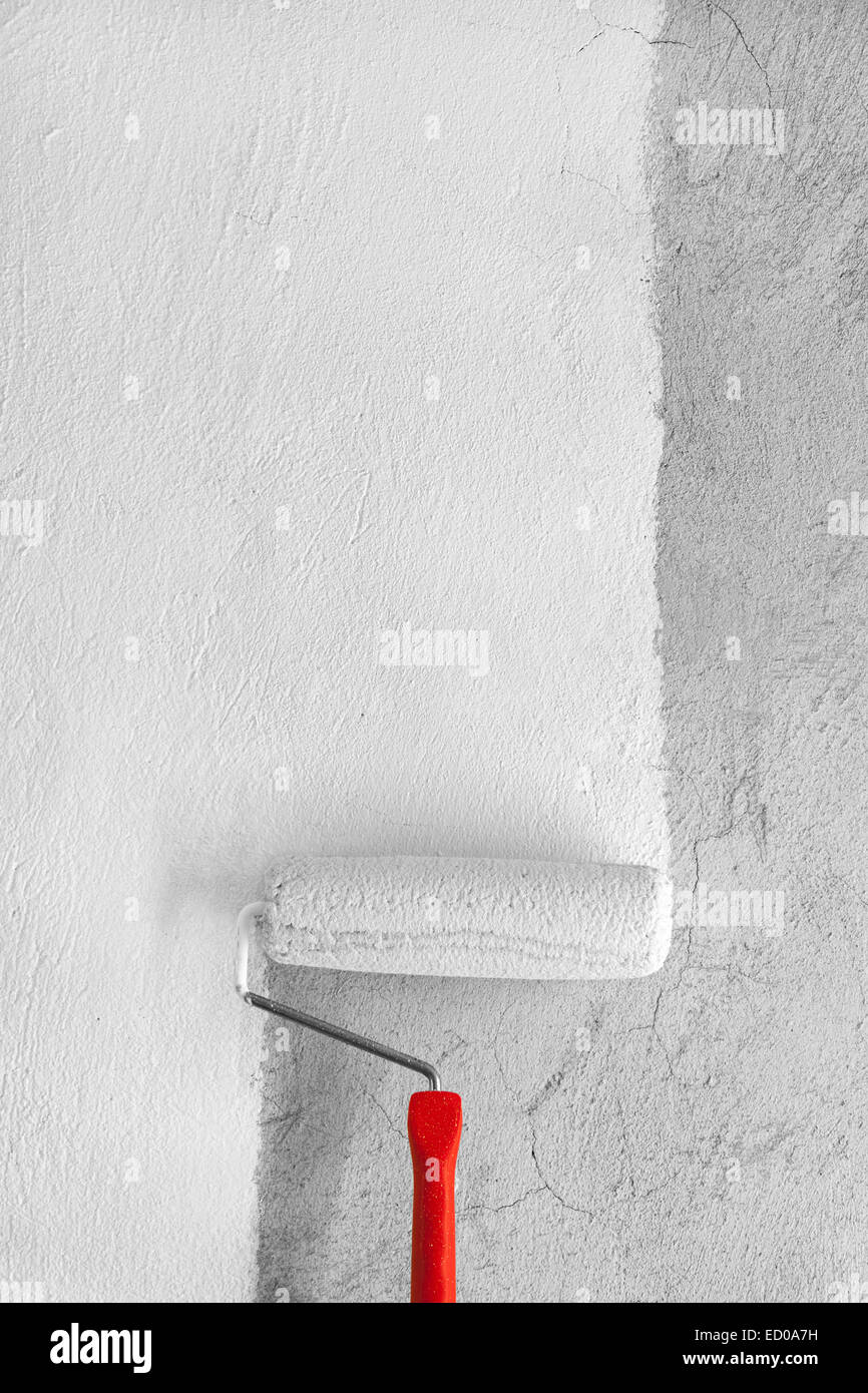 Painting a rough wall by painting roller Stock Photo Alamy