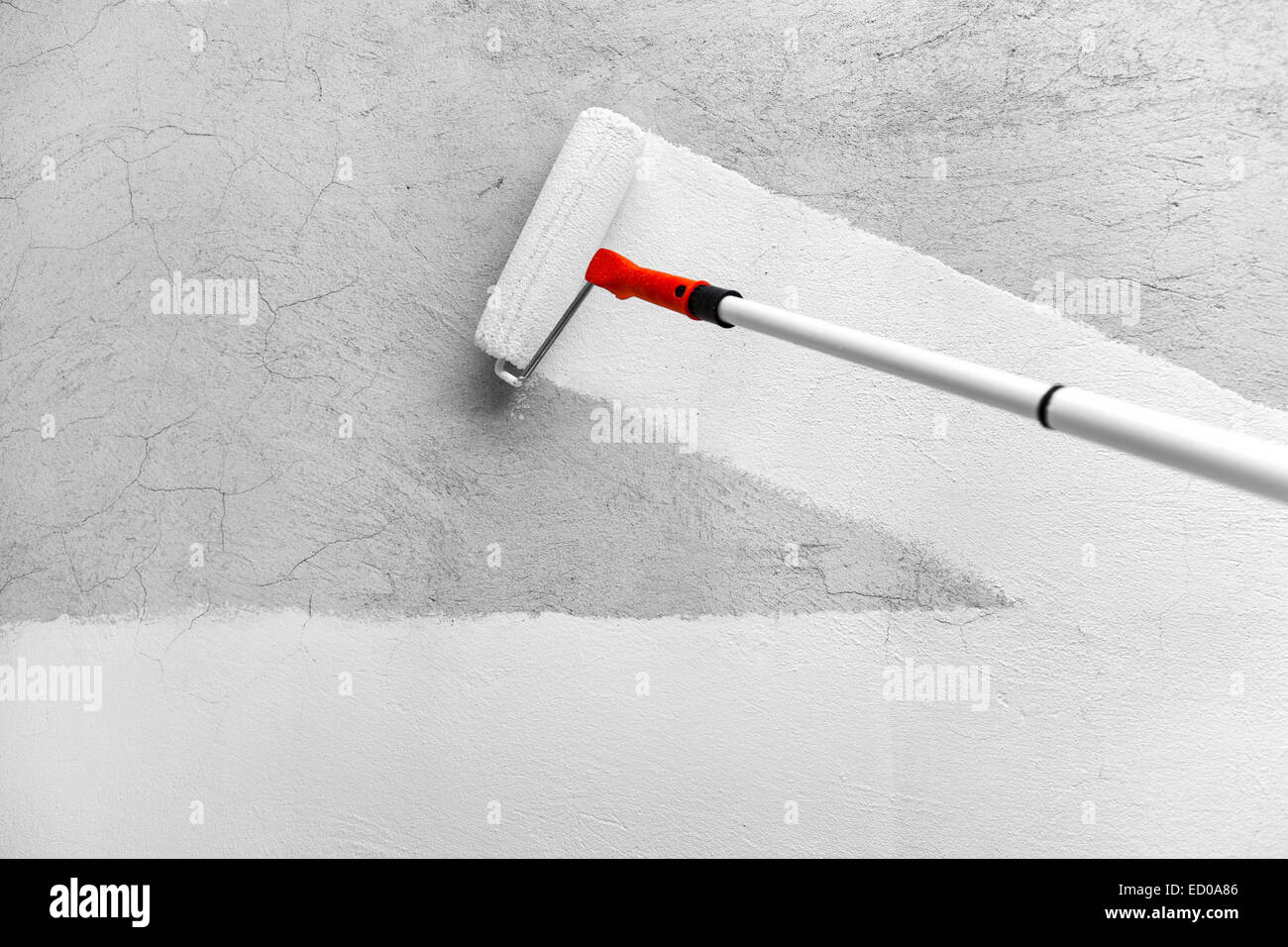 Painting a rough wall with white latex paint Stock Photo Alamy