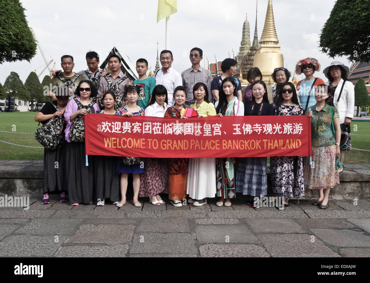 Group of Chinese tourists posing at the Outer court king's grand palace, Wat Phra Kaew, Bangkok, Thailand. Stock Photo