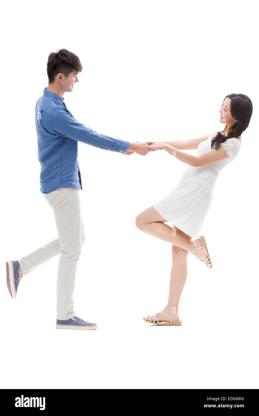 Happy young couple holding hands Stock Photo - Alamy
