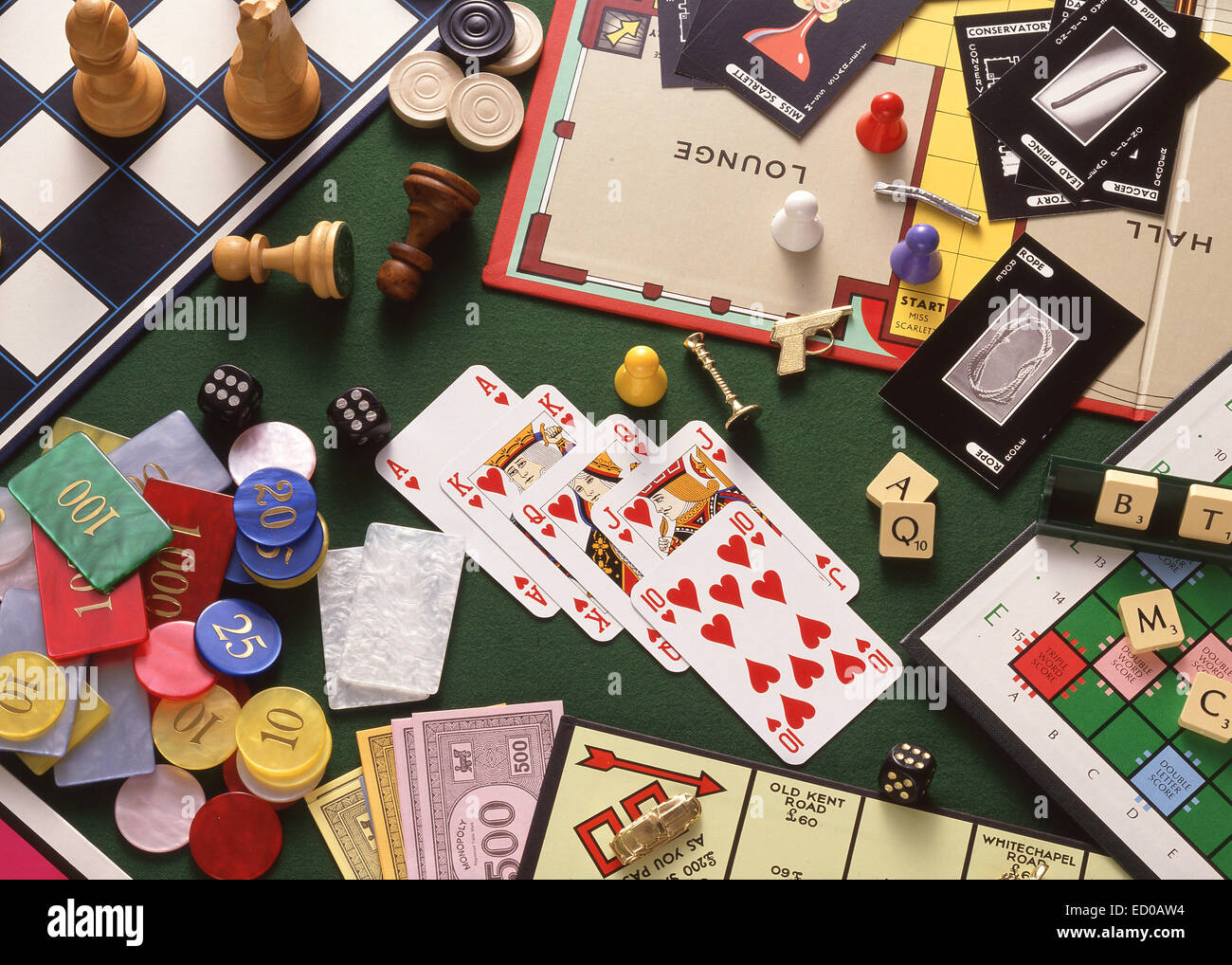 Still-life selection of board games (Monopoly, Chess, Cluedo, Scrabble) with playing cards and gambling chips Stock Photo