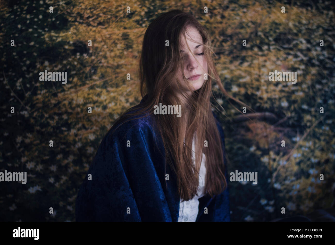 Portrait of young woman in a meadow with her eyes closed Stock Photo ...