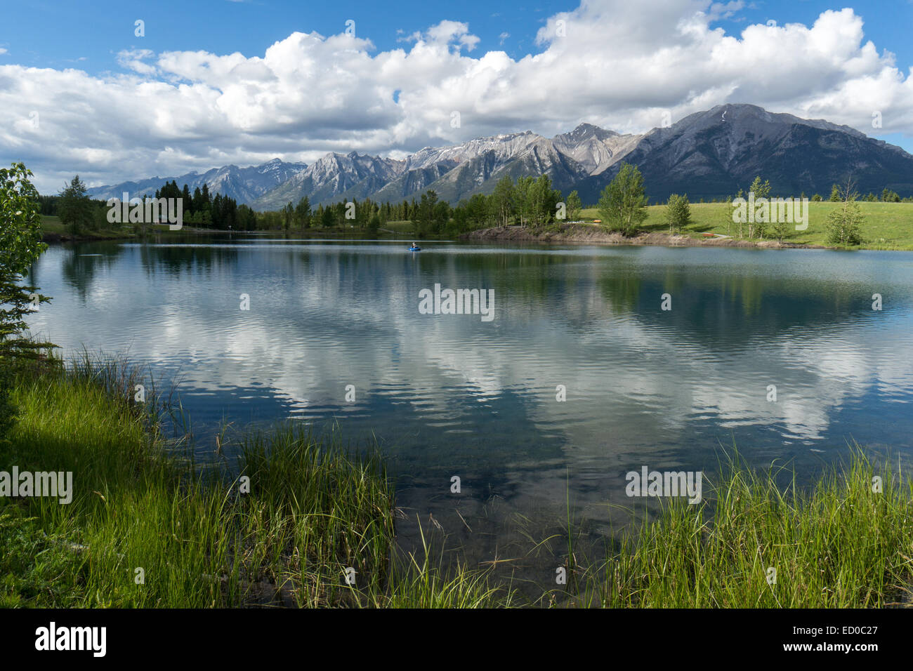 Canada, Quarry Lake, Fisherman in distance in tranquil landscape Stock Photo