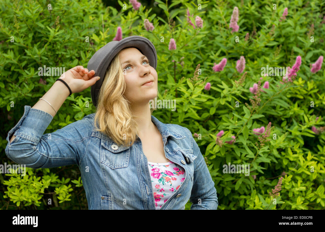 Girl (14-15) smiling and looking up Stock Photo