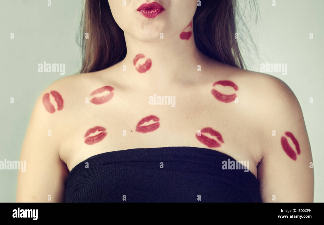 Lipstick kisses on teenage girl's (16-17) shoulders Stock Photo