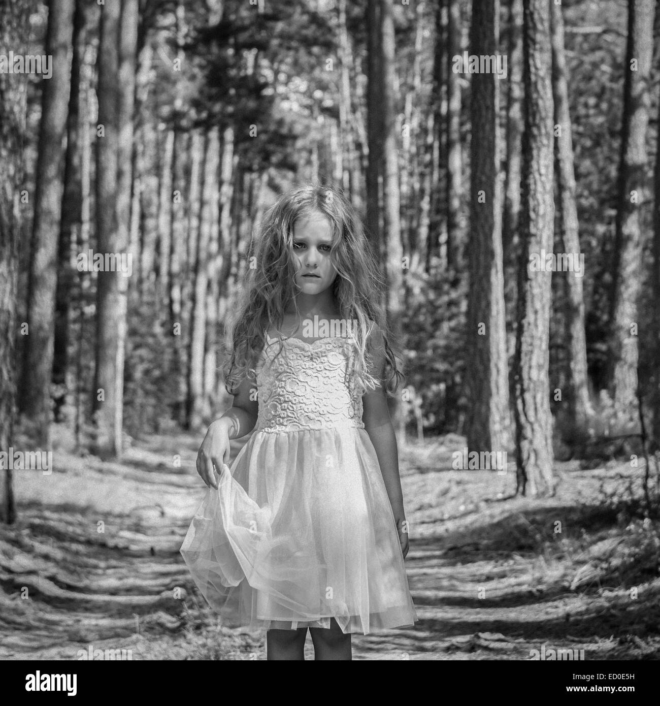 Portrait of sad girl (4-5) in forest Stock Photo