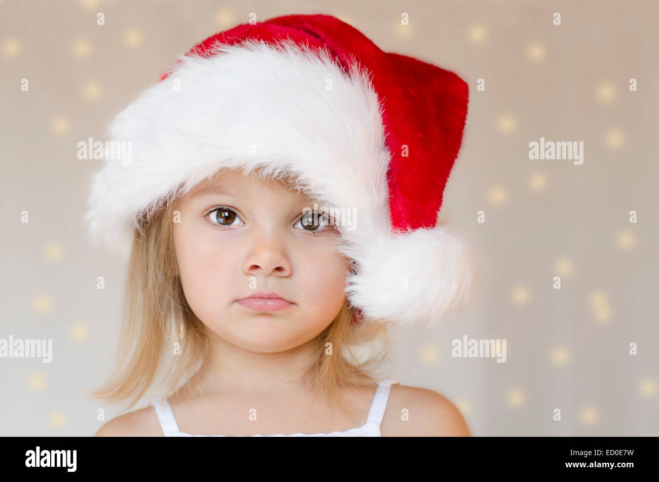 Portrait of a girl wearing a Santa Hat Stock Photo - Alamy
