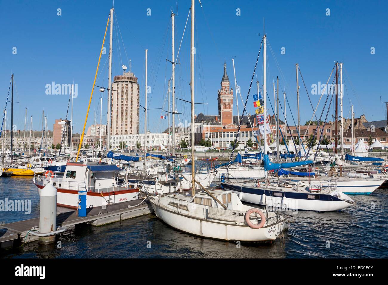 France, Nord, Dunkirk, boats in the marina and city hall belfry listed as World Heritage by UNESCO Stock Photo