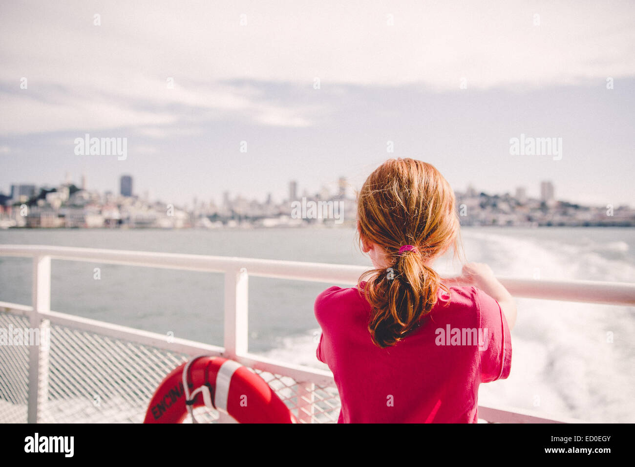 USA, California, San Francisco, Girl (6-7) on ferry looking at city skyline Stock Photo
