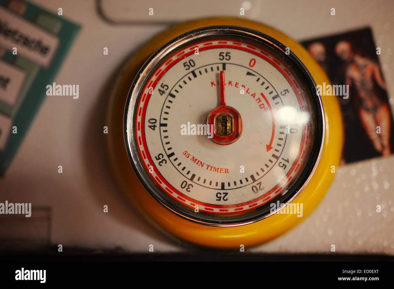 An old fashioned hour timer refrigerator magnet hanging on a refrigerator. Stock Photo