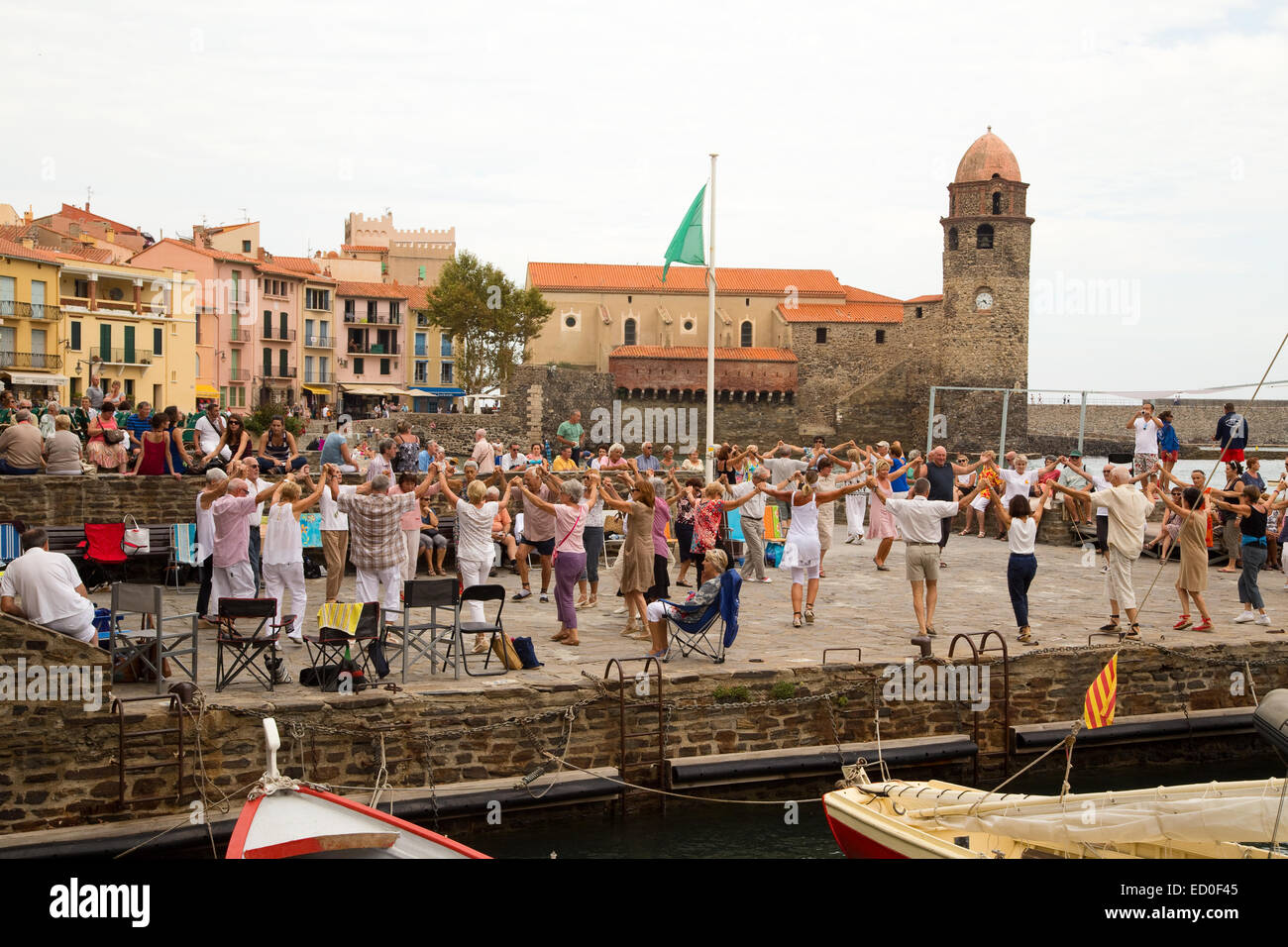 LONDON - SEPTEMBER 27TH: Catalan people dance their traditional Sardane on September 27th, 2014, in Collioure, France. Collioure Stock Photo