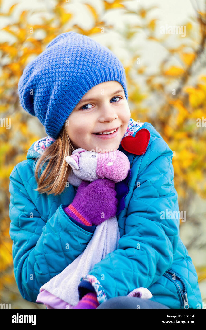 Portrait of smiling girl holding stuffed toy Stock Photo - Alamy