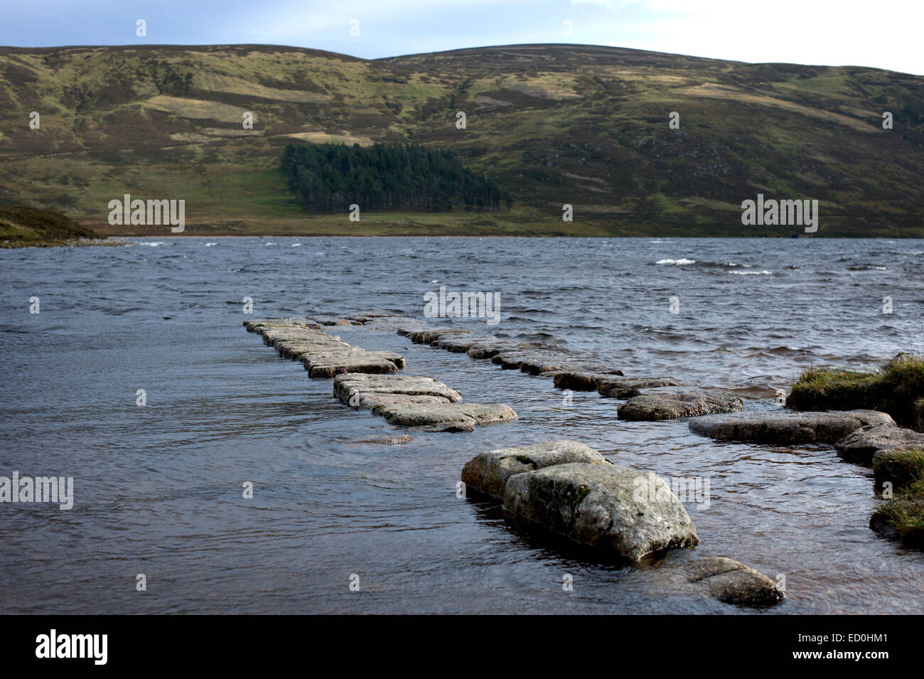Looking along rubble jetties of the boat slip at the upper end of Loch Muick in the Cairngorms National Park Stock Photo