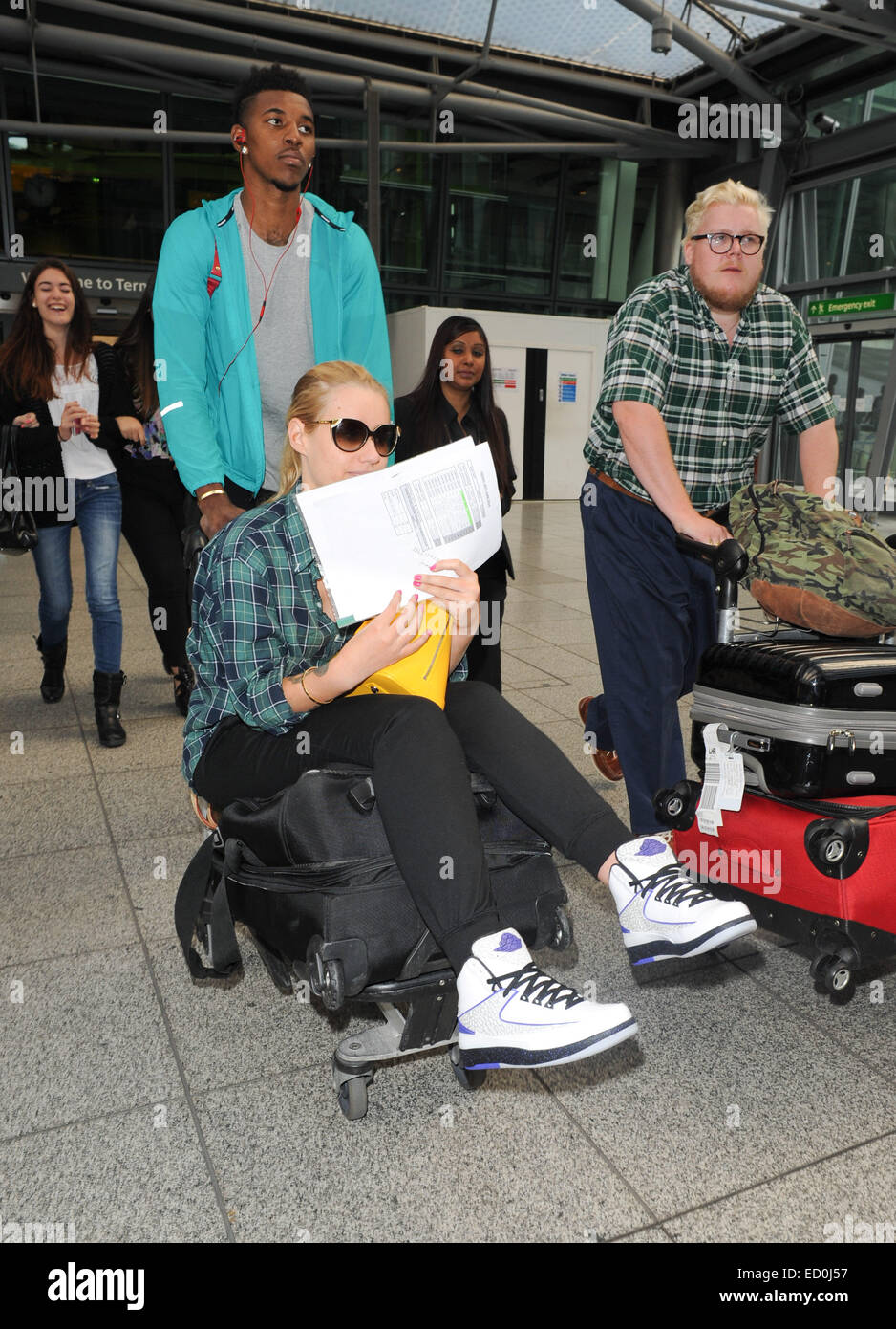 Iggy Azalea and boyfriend Nick Young arriving at Heathrow Airport  Featuring: Iggy Azalea,Nick Young Where: London, United Kingdom When: 20 Jun 2014 Stock Photo