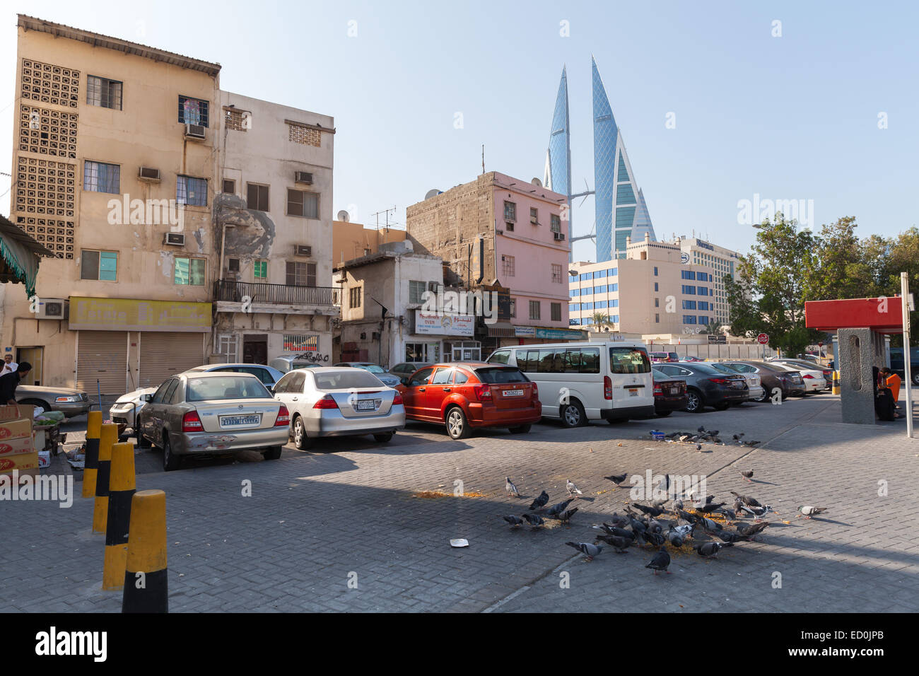 Manama, Bahrain - November 21, 2014: Street view with an old living houses and Bahrain World Trade Center in Manama city, Capita Stock Photo
