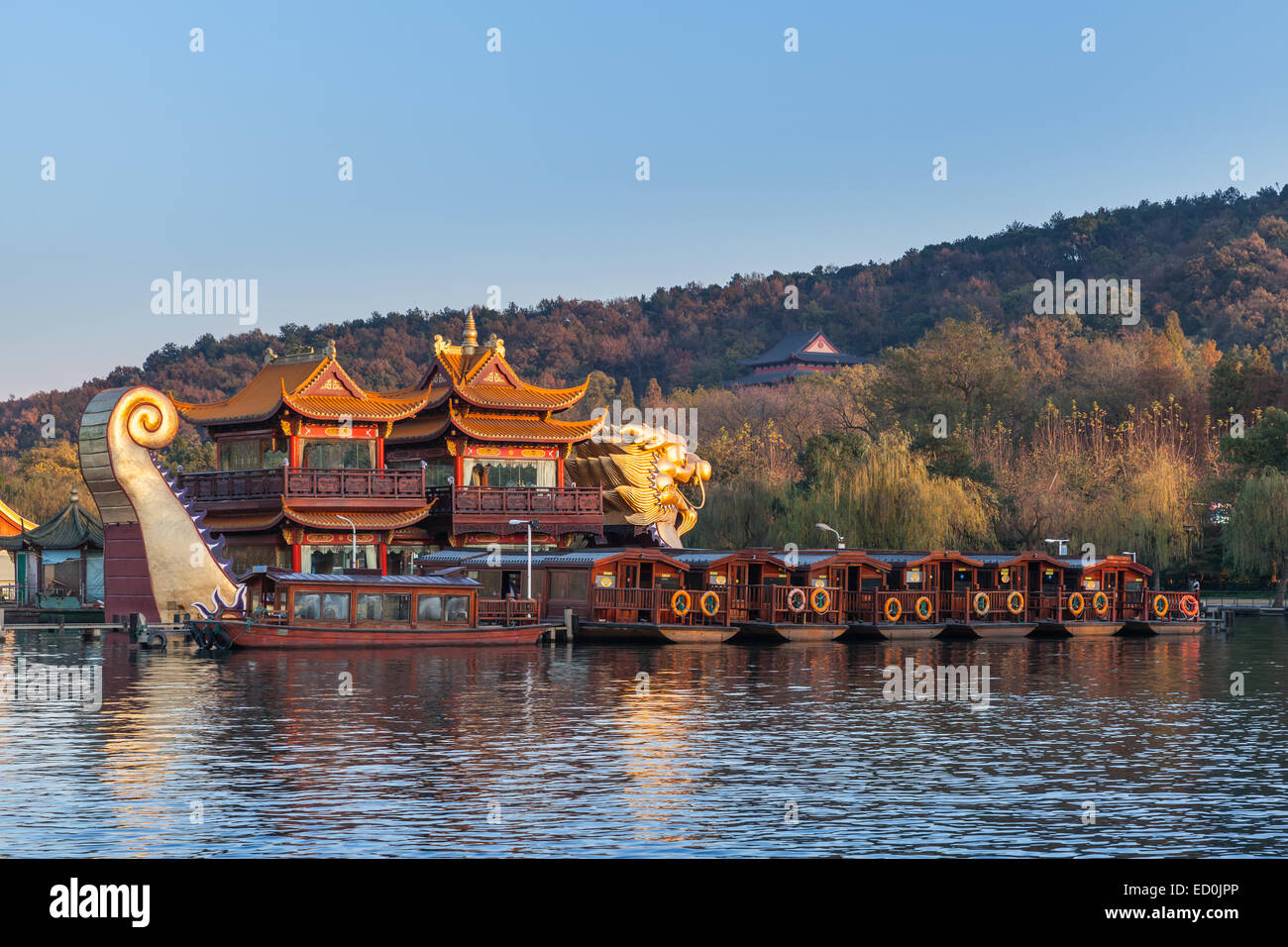 Hangzhou, China - December 5, 2014: Traditional Chinese wooden pleasure boats and Dragon ship stand on the West Lake. Famous par Stock Photo