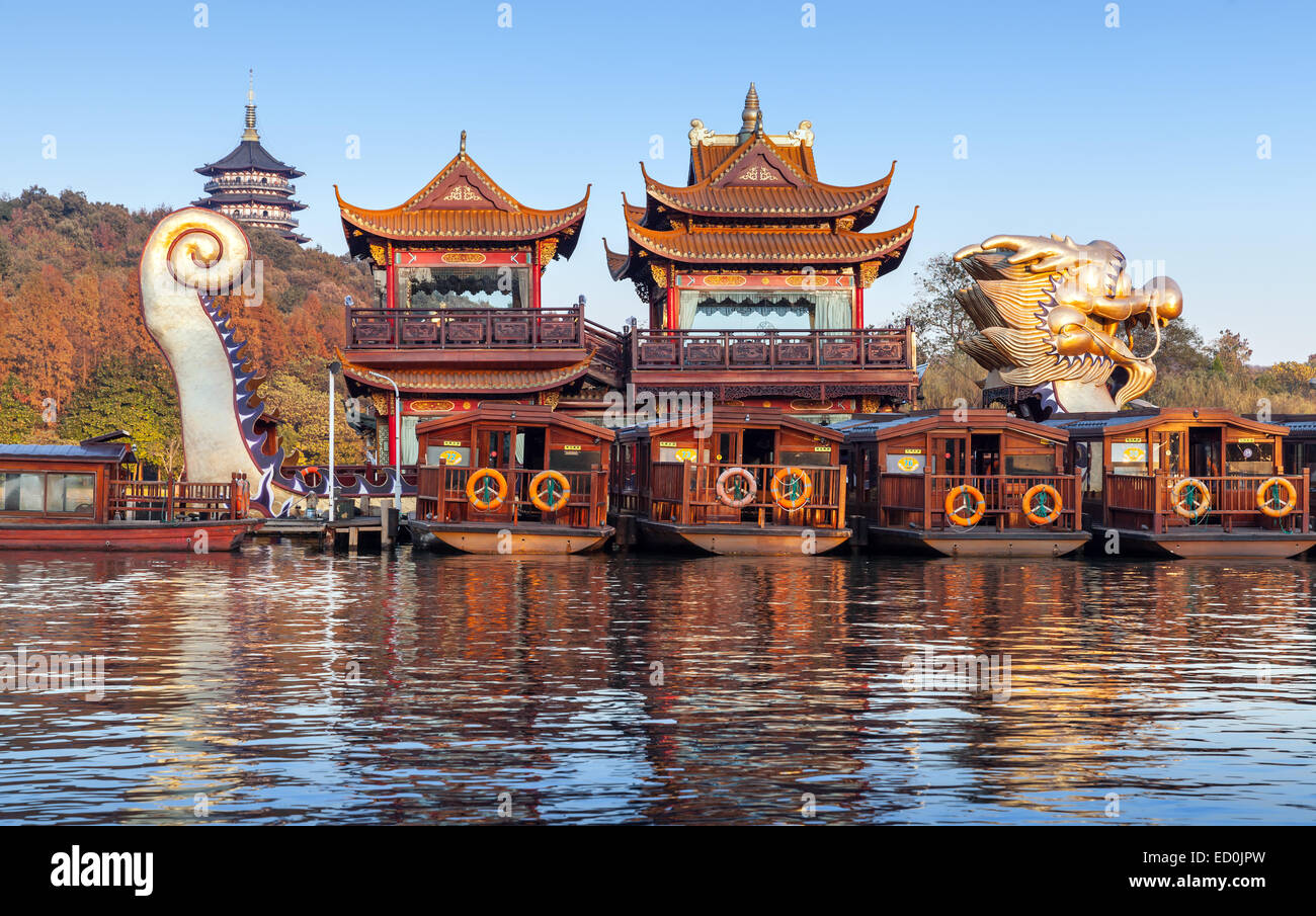 Hangzhou, China - December 5, 2014: Traditional Chinese wooden recreation boats and Dragon ship are moored on the West Lake Stock Photo