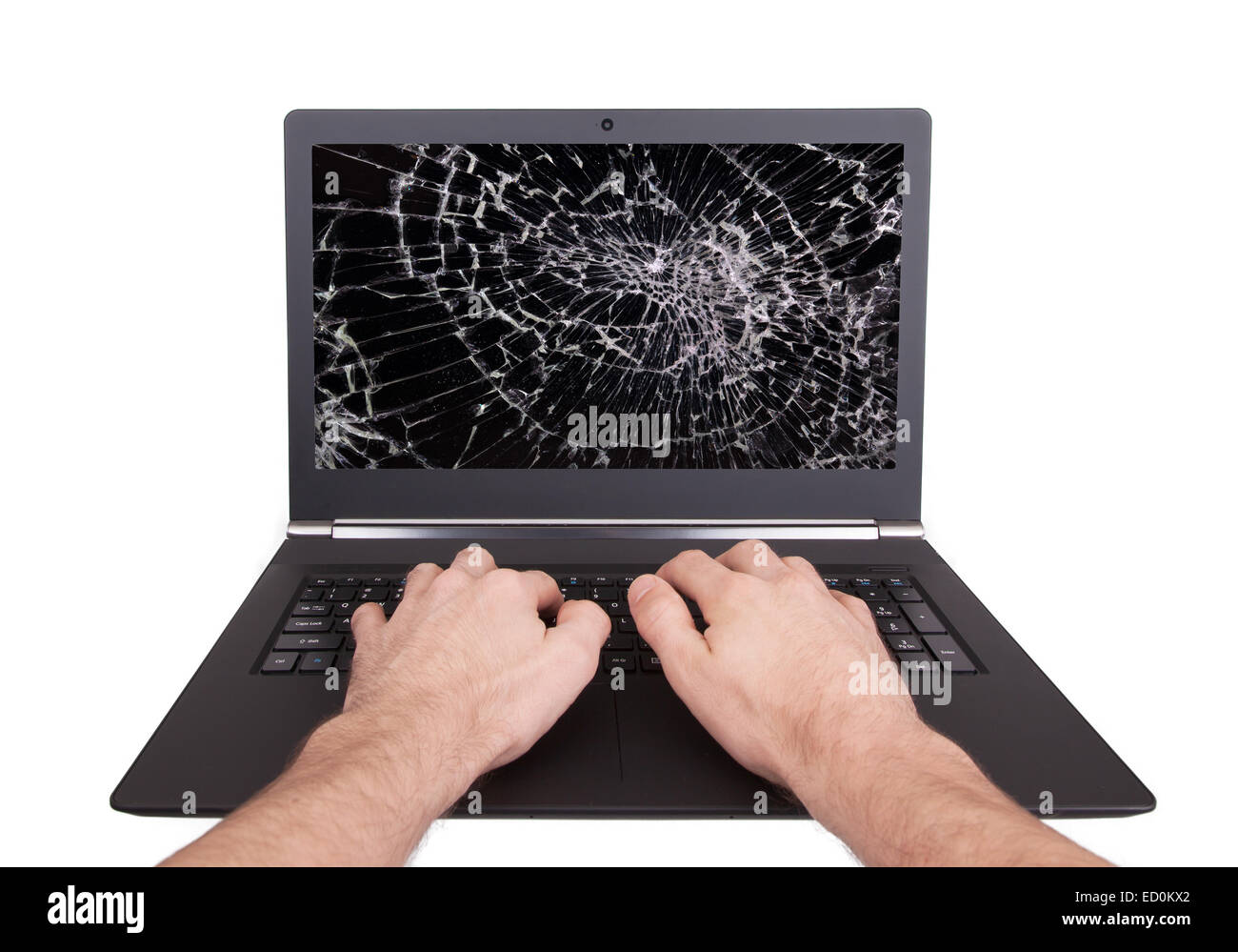 Man working on a laptop with a broken screen, black Stock Photo