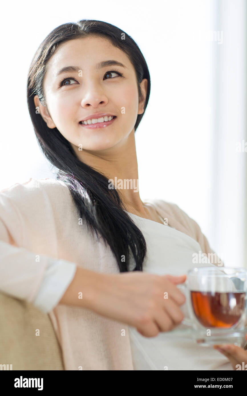 Happy young woman drinking black tea Stock Photo Alamy